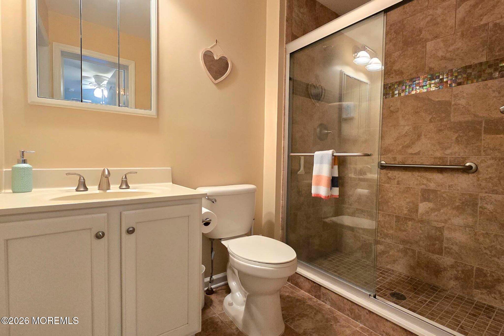 111 President Avenue Lavallette, NJ 08735 - Photo 13 of 54 a bathroom with a sink mirror toilet and shower
