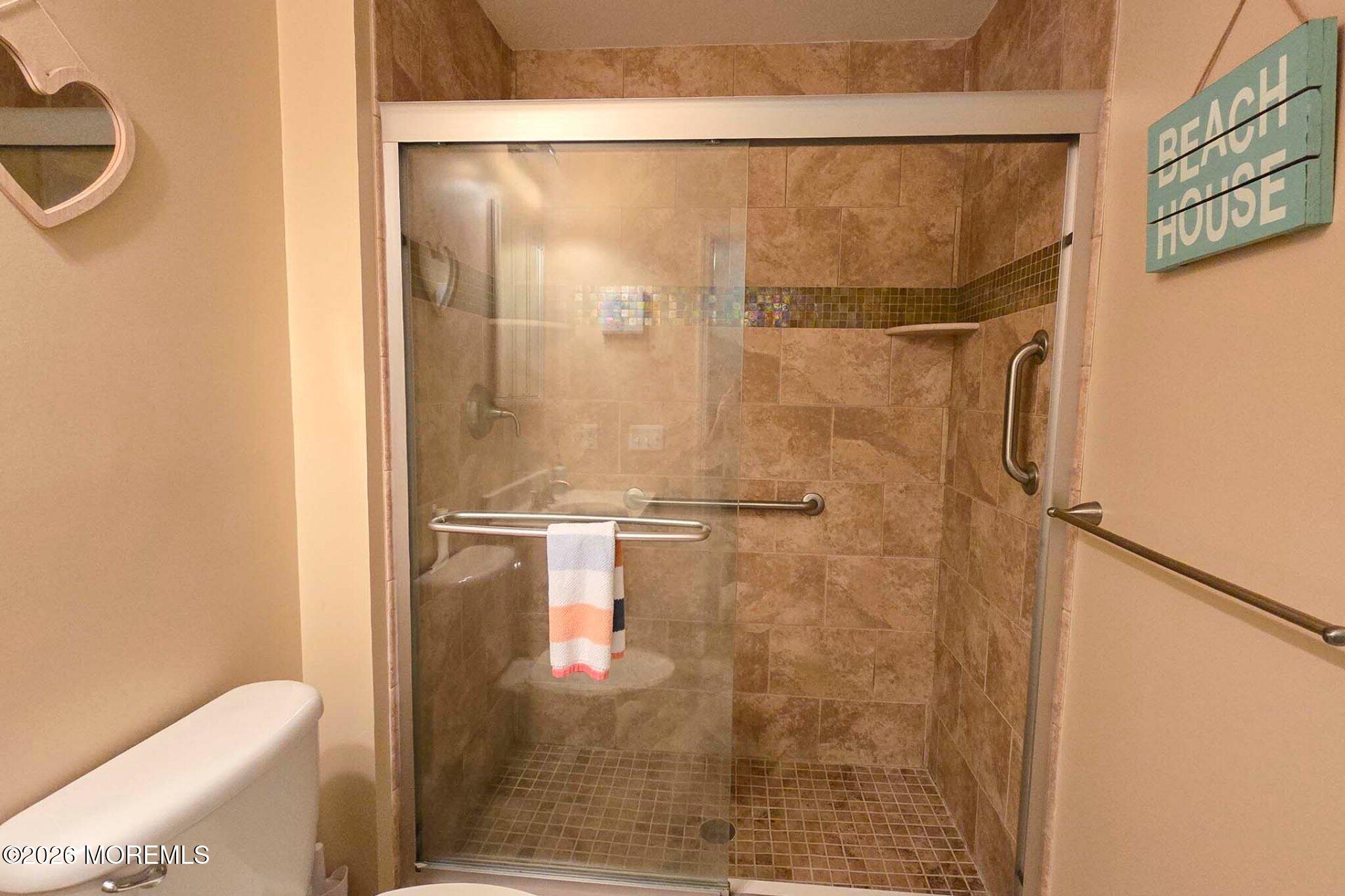 111 President Avenue Lavallette, NJ 08735 - Photo 14 of 54 a bathroom with a glass shower door