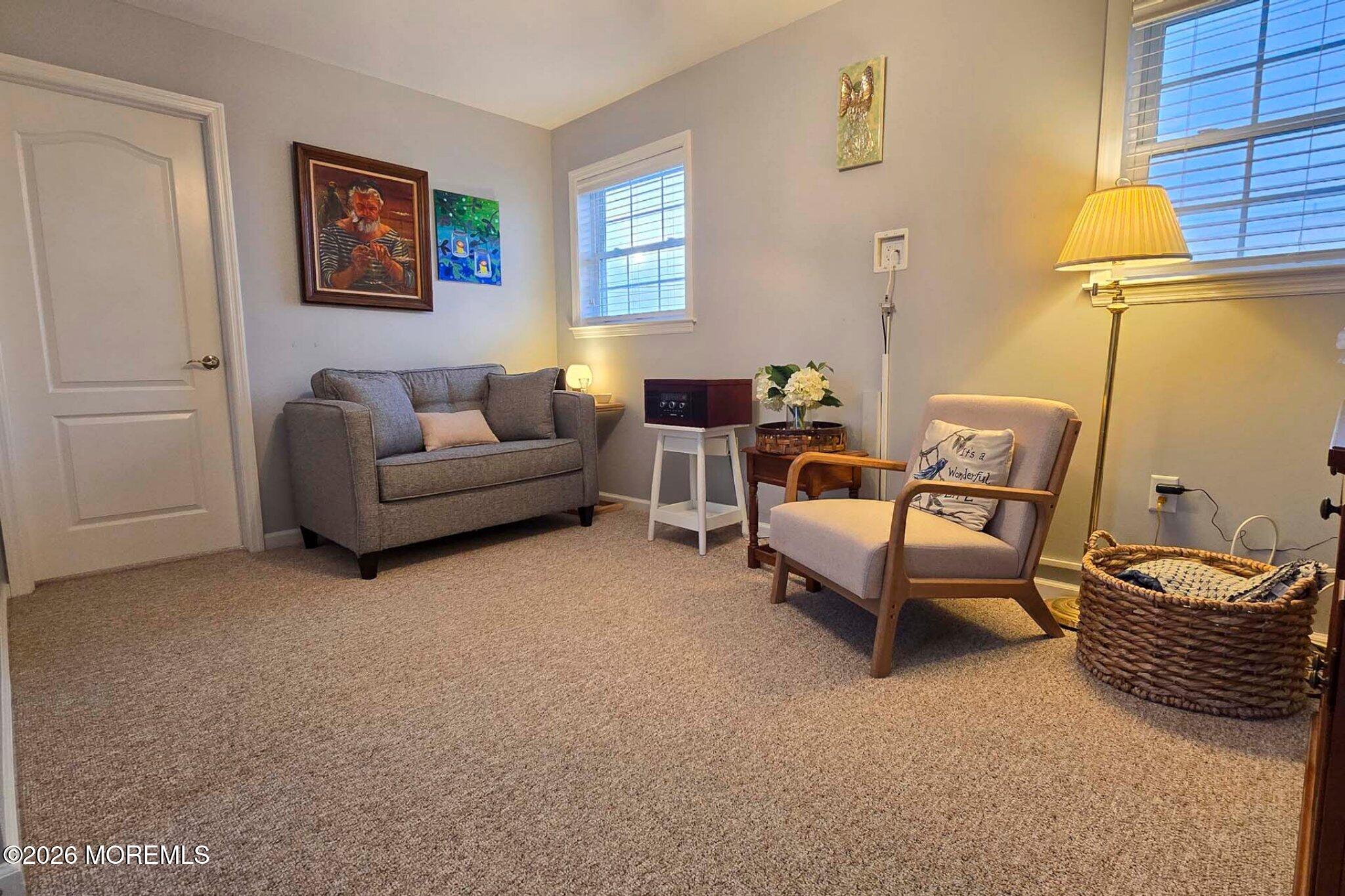 111 President Avenue Lavallette, NJ 08735 - Photo 20 of 54 a living room with furniture a couch and paintings on the wall