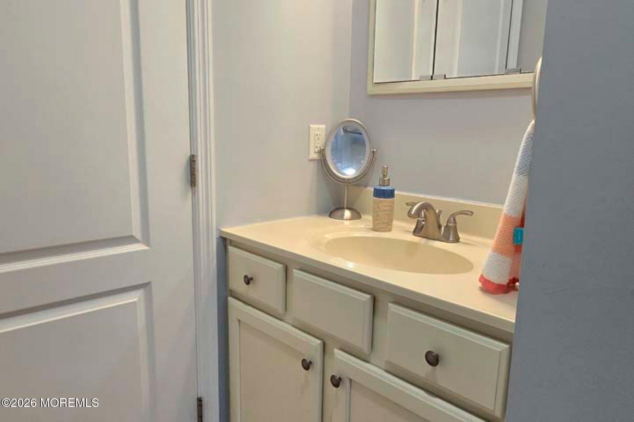 111 President Avenue Lavallette, NJ 08735 - Photo 27 of 54 a bathroom with a sink and a mirror