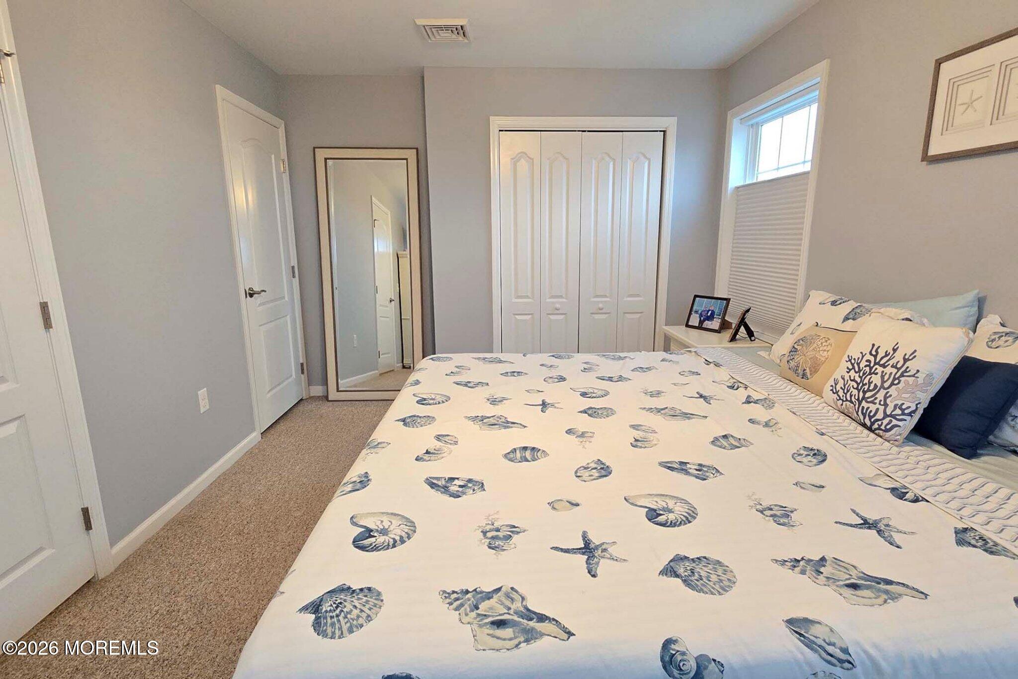 111 President Avenue Lavallette, NJ 08735 - Photo 29 of 54 a bedroom with a bed and a window