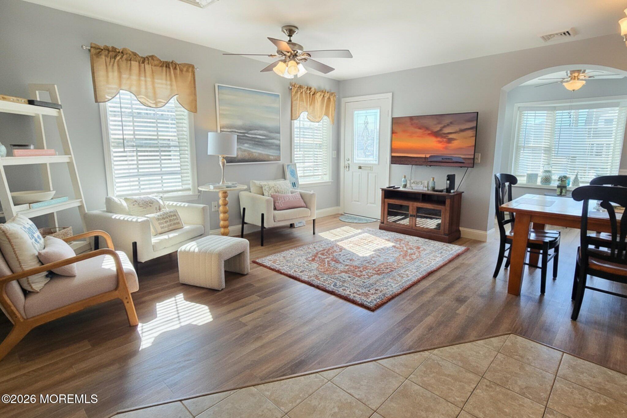 111 President Avenue Lavallette, NJ 08735 - Photo 6 of 54 a living room with furniture floor to ceiling window hardwood floor and a flat screen tv