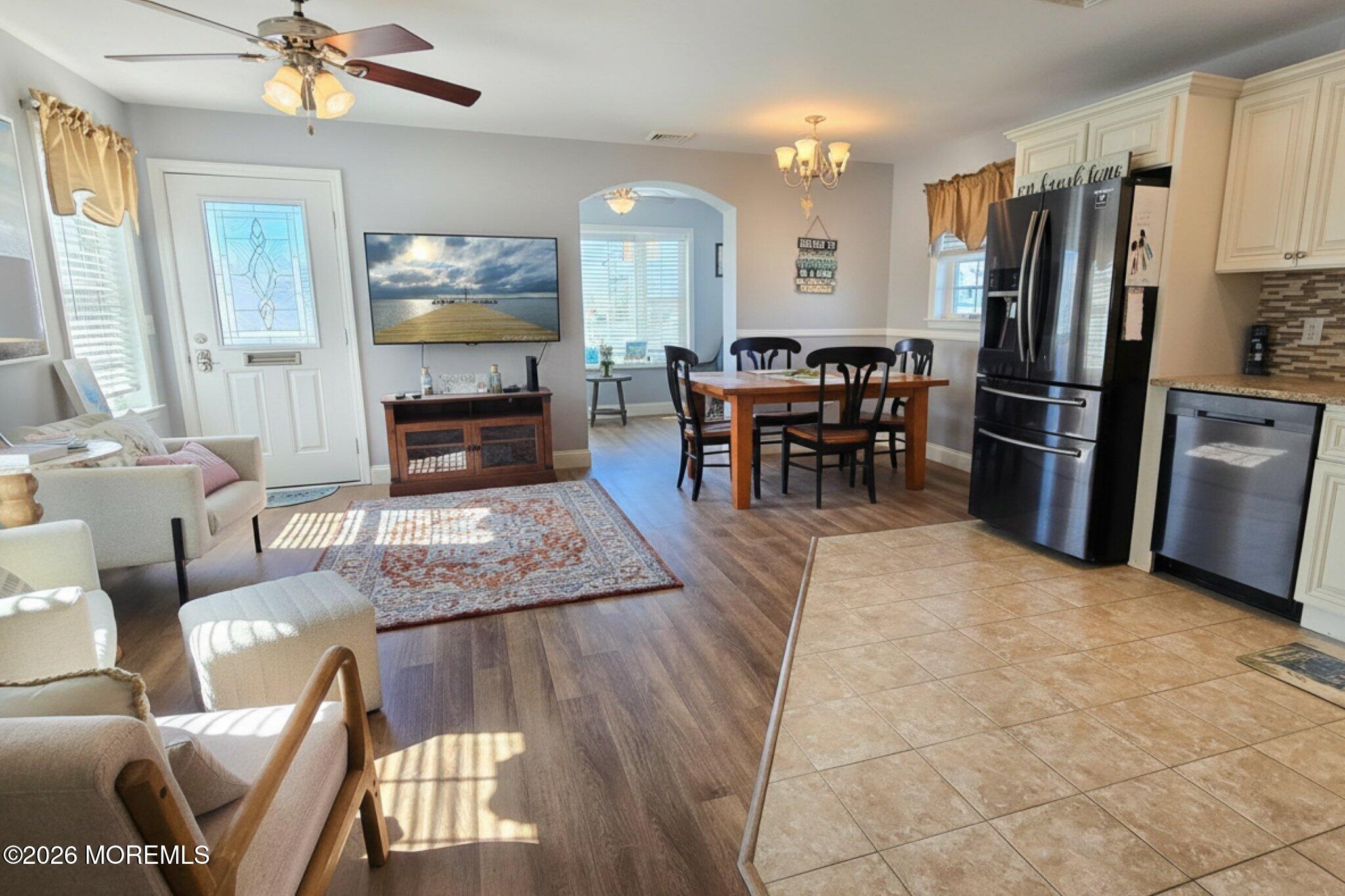 111 President Avenue Lavallette, NJ 08735 - Photo 8 of 54 a living room with furniture a fireplace and a chandelier