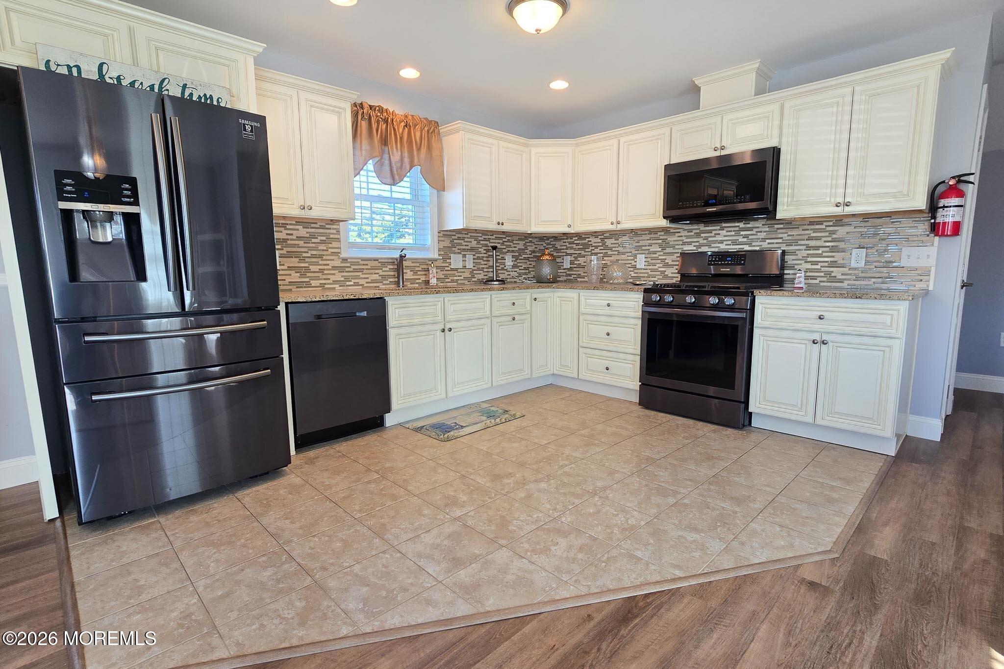 111 President Avenue Lavallette, NJ 08735 - Photo 9 of 54 a kitchen with granite countertop a refrigerator stove and microwave
