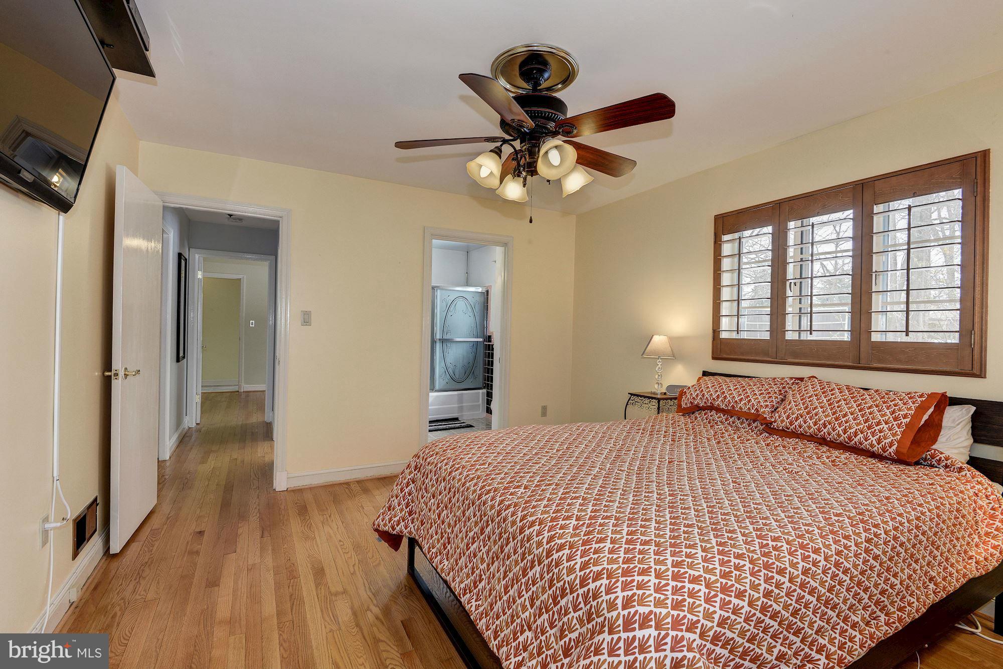1301 Chalmers Road Silver Spring, MD 20903 - Photo 16 of 28 a bedroom with a bed and a chandelier