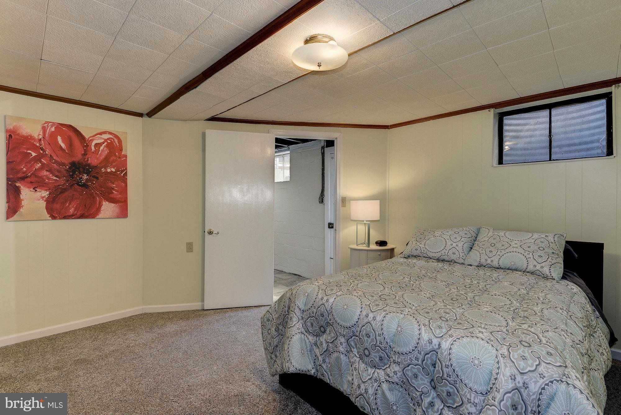 1301 Chalmers Road Silver Spring, MD 20903 - Photo 17 of 28 a bedroom with a bed and a painting on the wall