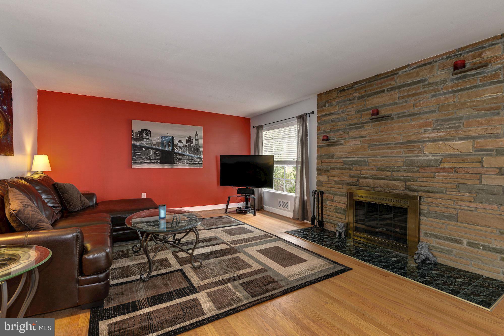 1301 Chalmers Road Silver Spring, MD 20903 - Photo 7 of 28 a living room with furniture and a fireplace