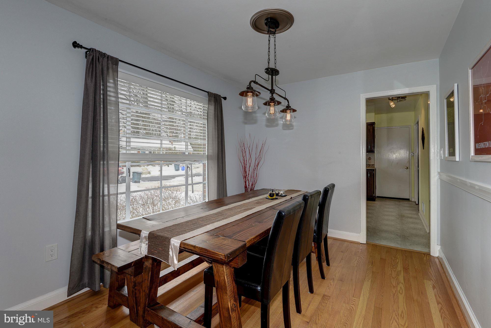 1301 Chalmers Road Silver Spring, MD 20903 - Photo 10 of 28 a view of a dining room with furniture window and wooden floor