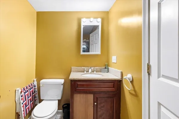 a kitchen with stainless steel appliances granite countertop a stove a refrigerator a sink a microwave and wooden cabinets