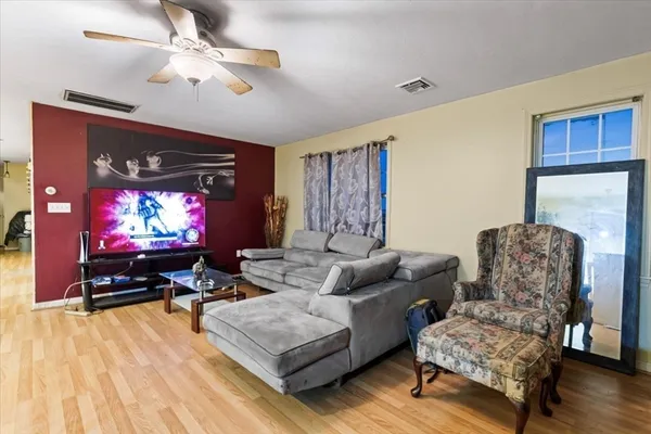 a living room with furniture and a flat screen tv