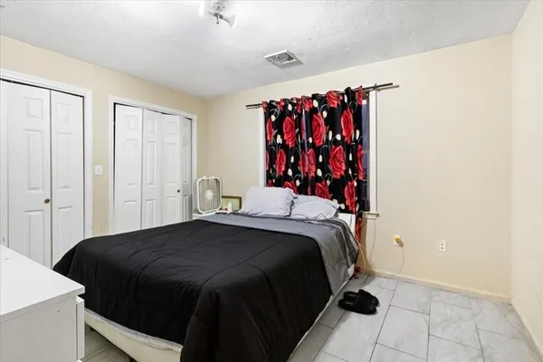 a bathroom with a sink a mirror a shower curtain and a window