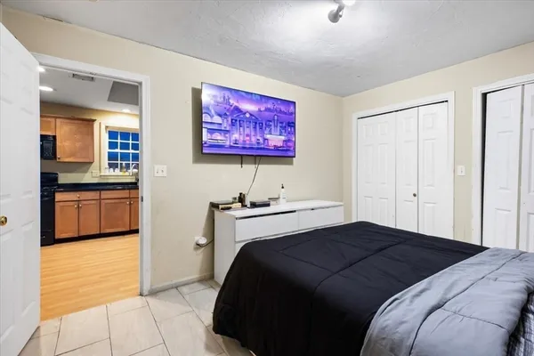 a utility room with a washing machine and a chair