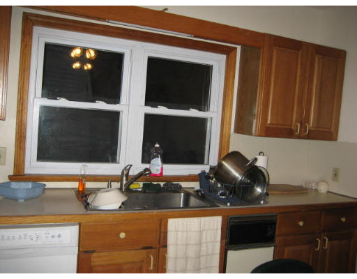 a kitchen with granite countertop a sink and a stove
