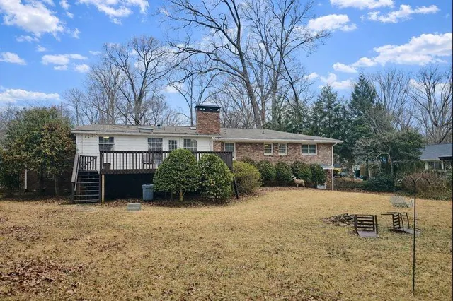 a view of a house with a yard and trees