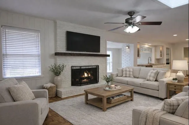 a living room with furniture a flat screen tv and a fireplace