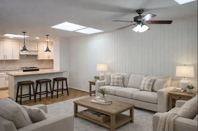 a living room with furniture a dining table and a fireplace