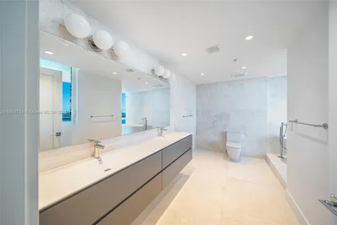 a large bathroom with a large tub and double vanity