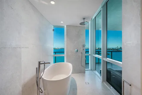 a spacious bathroom with a bathtub and sink