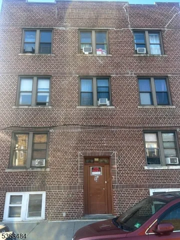 a bathroom with a bathtub a window and a shower