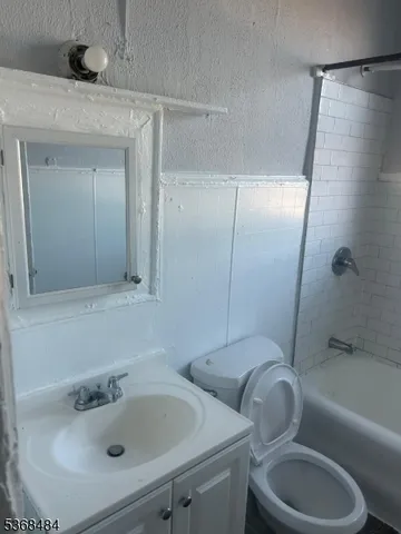 a bathroom with a sink a toilet and bathtub