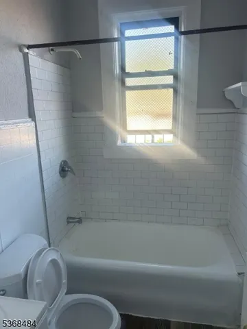 a kitchen with granite countertop white cabinets and stainless steel appliances
