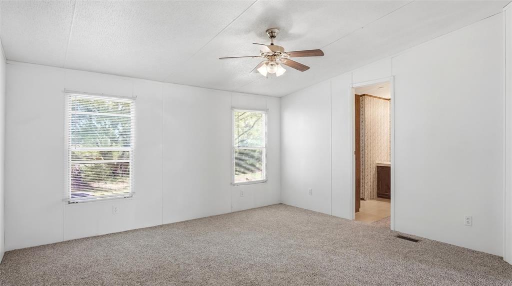 10902 County Road 414 Merkel, TX 79536 - Photo 17 of 26 an empty room with windows and fan
