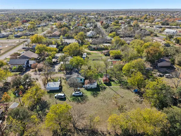 an aerial view of a houses with a yard