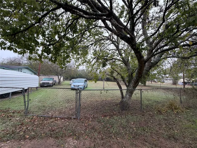 a backyard of a house with table and chairs