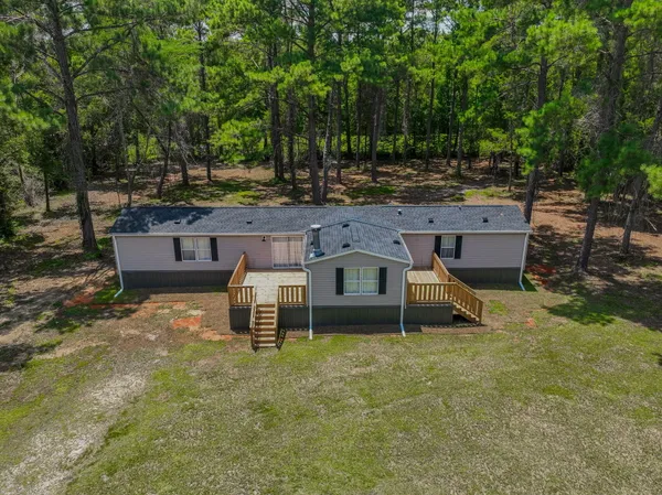 an aerial view of a house with a yard