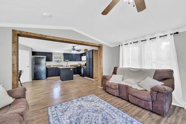 a living room with furniture and a kitchen