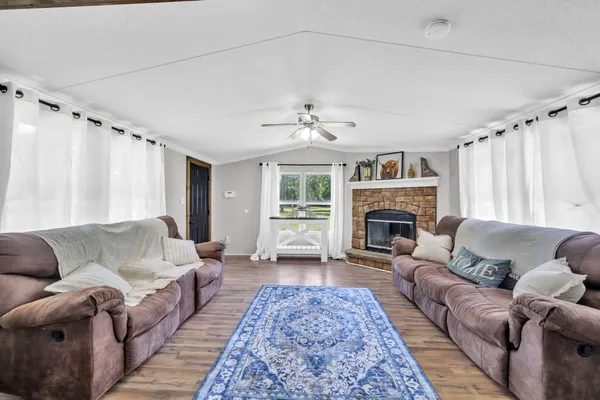 a living room with furniture and a fireplace