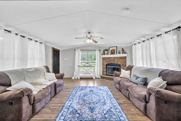 a living room with furniture a fireplace and a chandelier