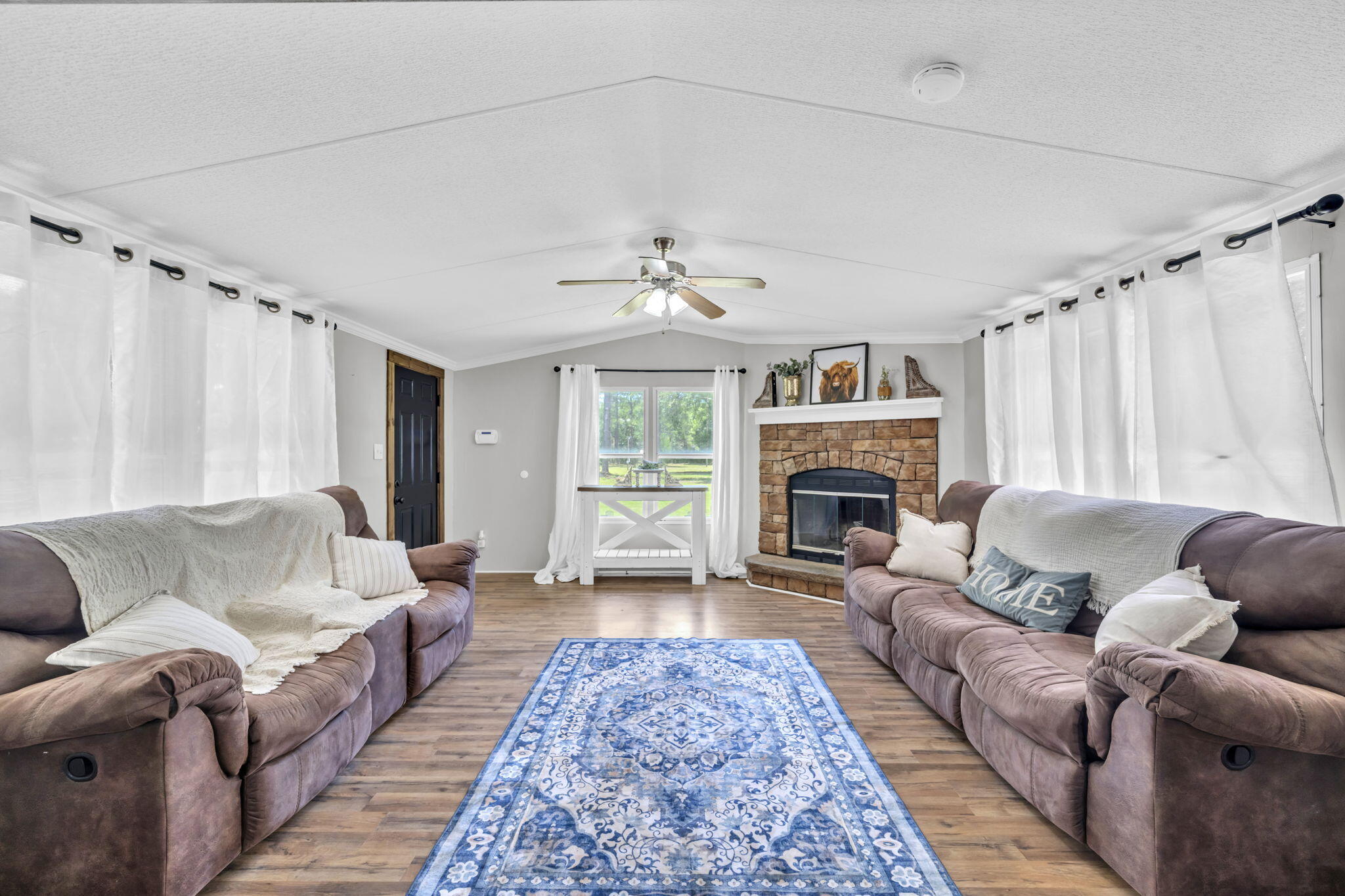 5216 Galiver Cutoff Baker, FL 32531 - Photo 21 of 51 a living room with furniture a fireplace and a chandelier