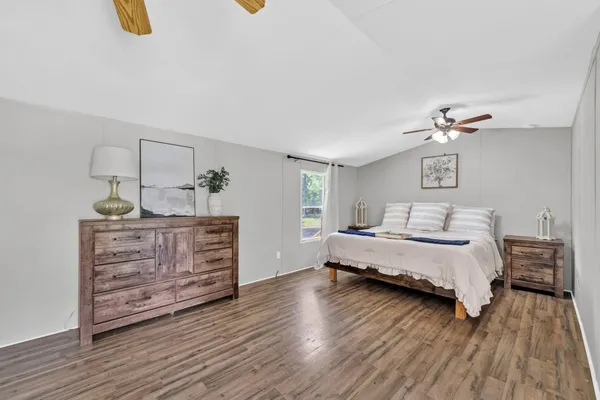 a bedroom with furniture and wooden floor