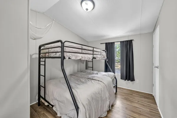 a bedroom with a bed and a mirror