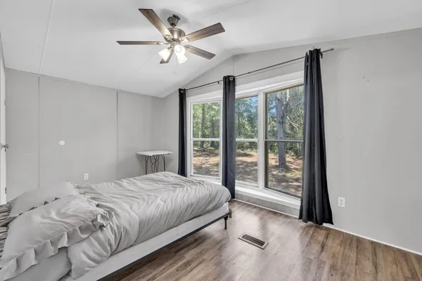 a bedroom with a large bed and a large window