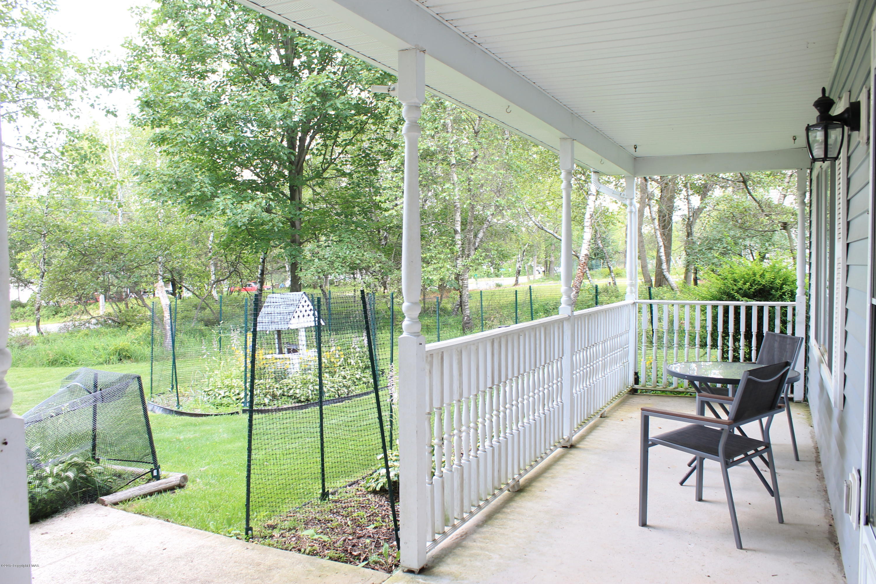 169 Ryan Road Blakeslee, PA 18610 - Photo 3 of 22 a view of a deck with a floor to ceiling window and a yard