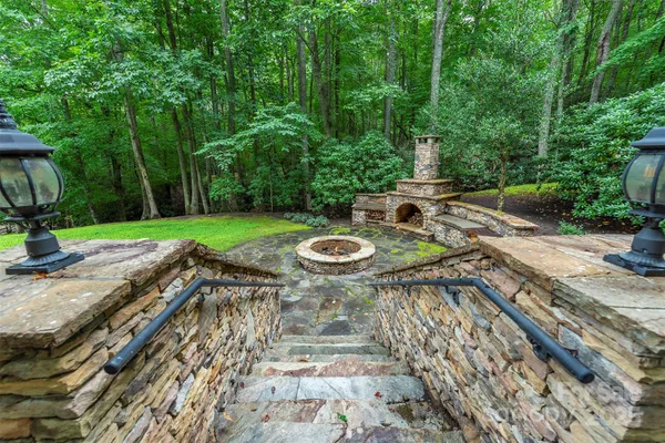a swimming pool with barbeque oven in back yard
