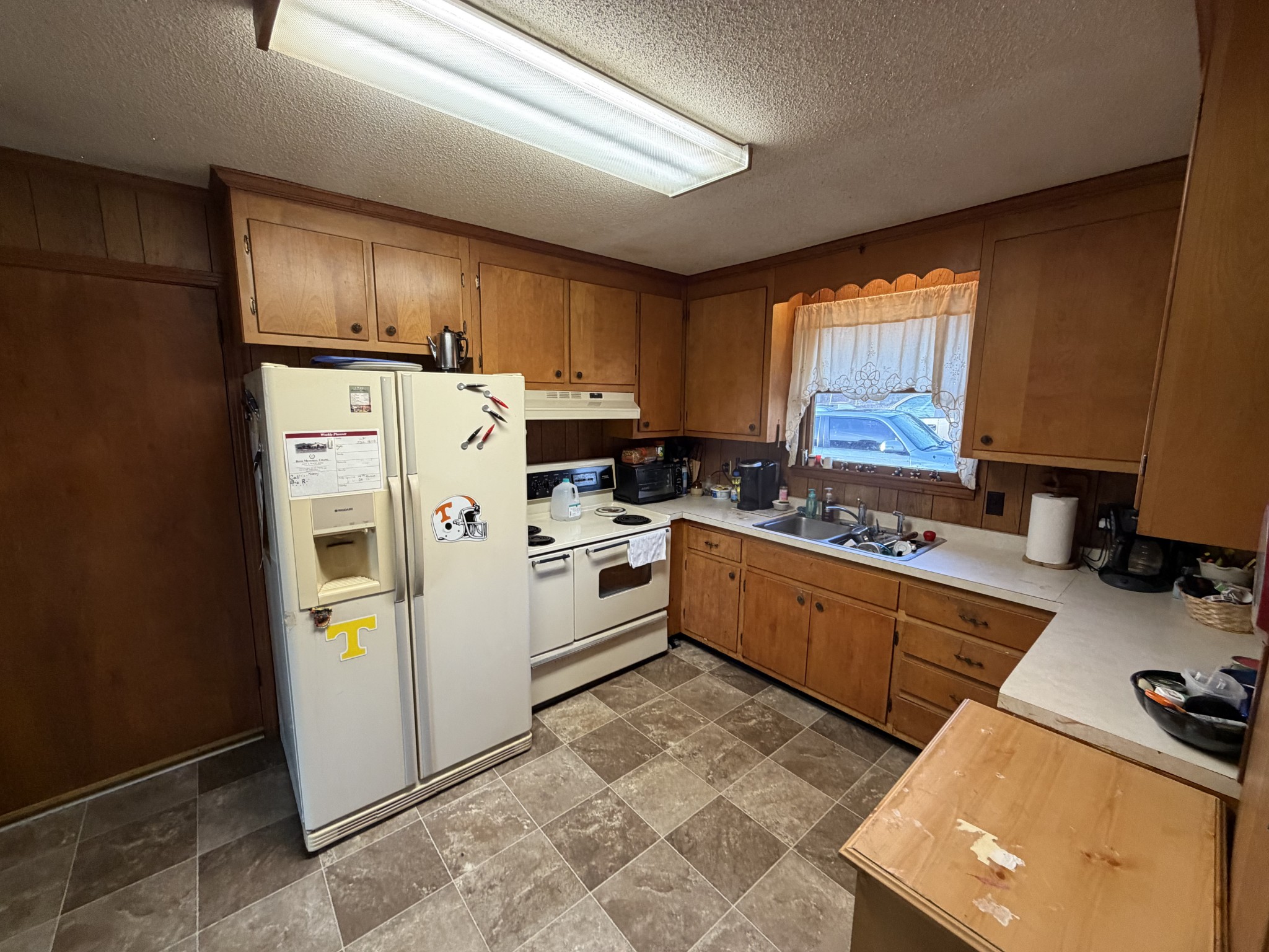 10555 Lebanon Road Mount Juliet, TN 37122 - Photo 5 of 15 a kitchen with a refrigerator a stove a sink dishwasher and wooden cabinets with wooden floor