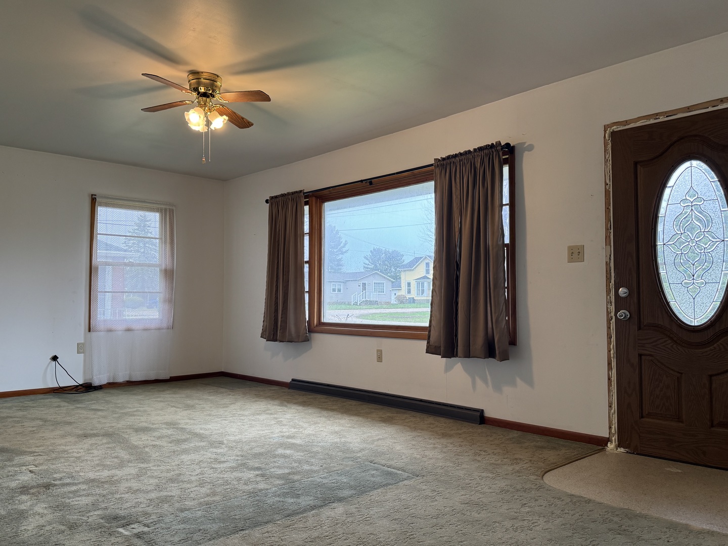 101 West High Street La Moille, IL 61330 - Photo 3 of 34 an empty room with windows and fan