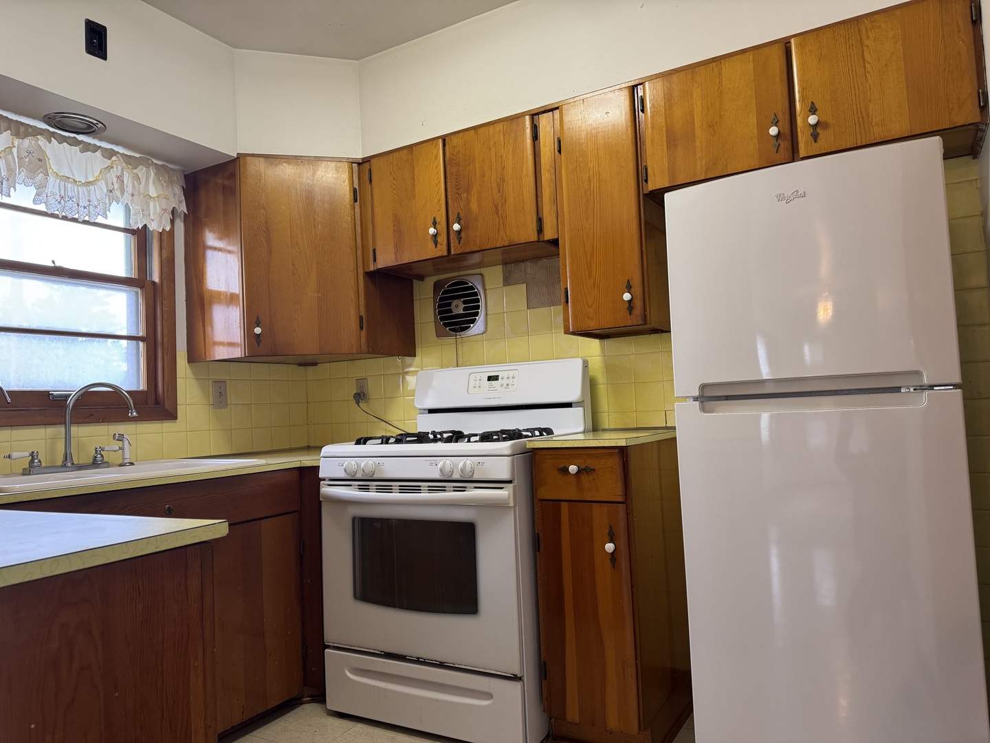 101 West High Street La Moille, IL 61330 - Photo 7 of 34 a kitchen with a stove a refrigerator and a sink