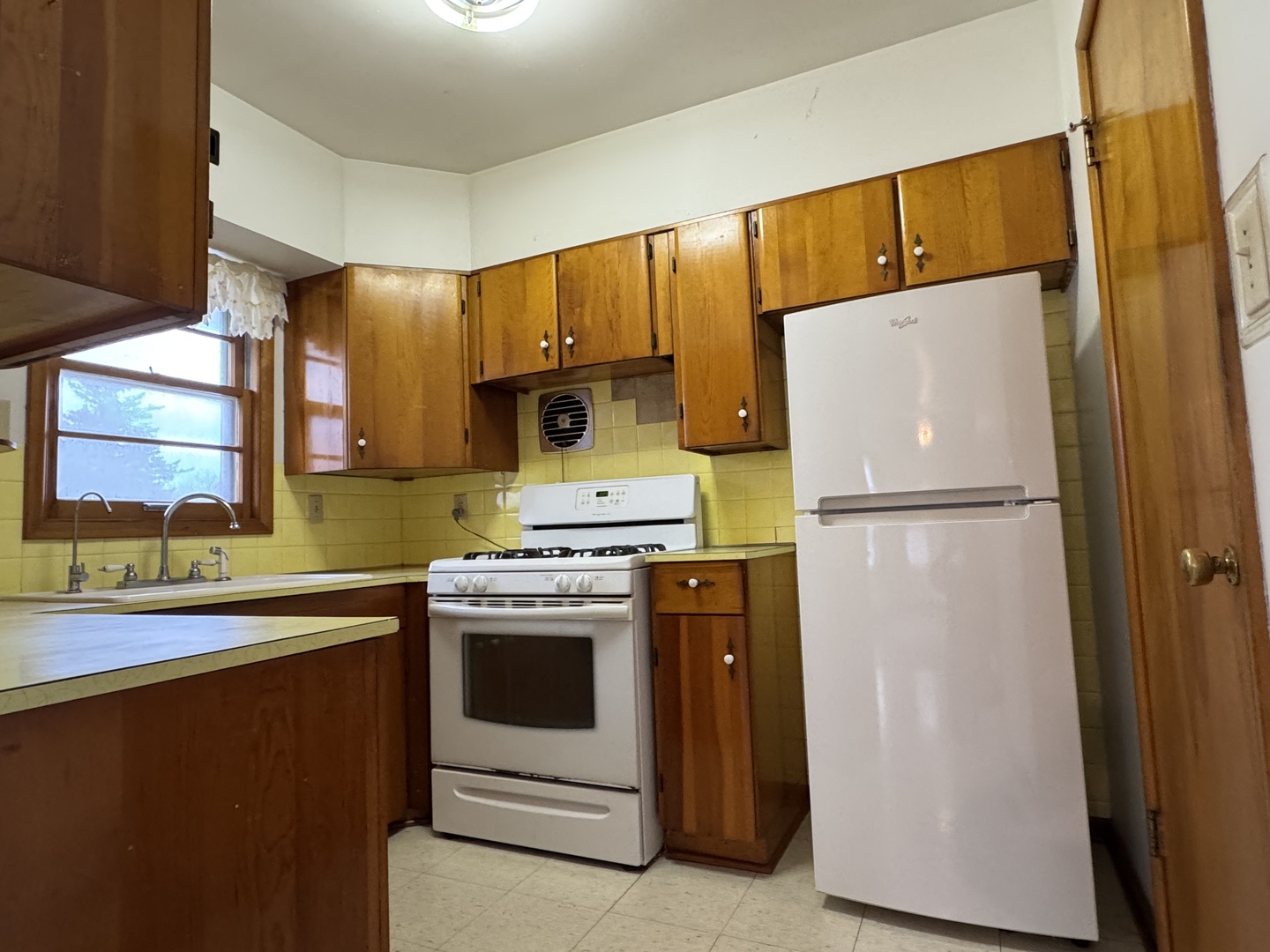 101 West High Street La Moille, IL 61330 - Photo 10 of 34 a kitchen with a refrigerator sink stove and cabinets
