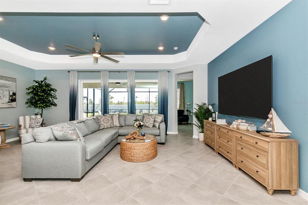 17180 Jadestone Court Venice, FL 34293 - Photo 11 of 98 a living room with furniture and a flat screen tv