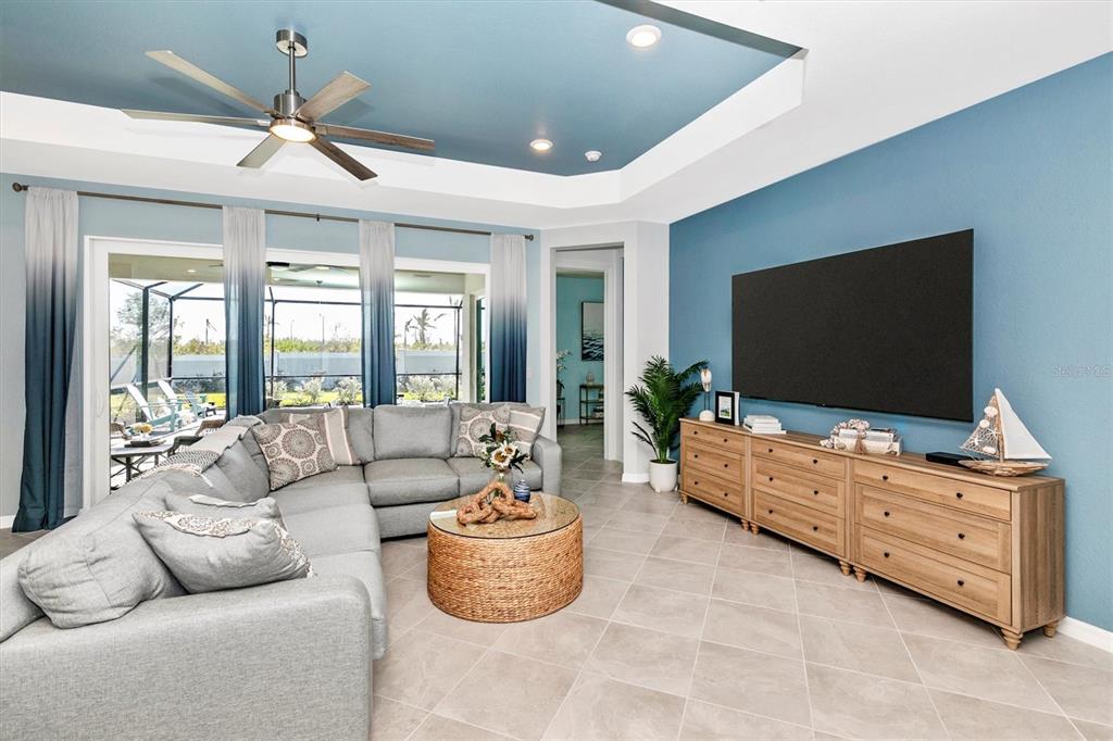 17180 Jadestone Court Venice, FL 34293 - Photo 12 of 98 a living room with furniture and a flat screen tv