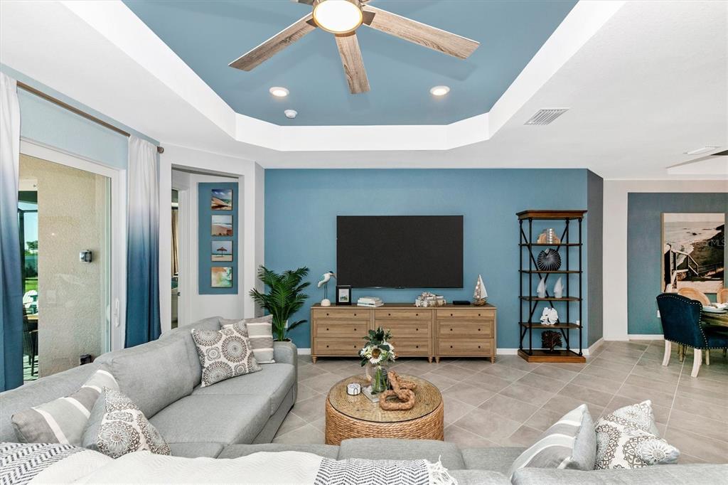 17180 Jadestone Court Venice, FL 34293 - Photo 13 of 98 a living room with furniture and a flat screen tv