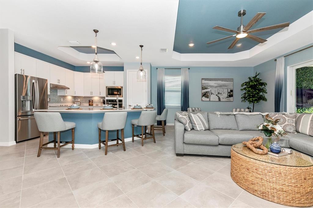 17180 Jadestone Court Venice, FL 34293 - Photo 15 of 98 a living room with furniture kitchen view and a chandelier