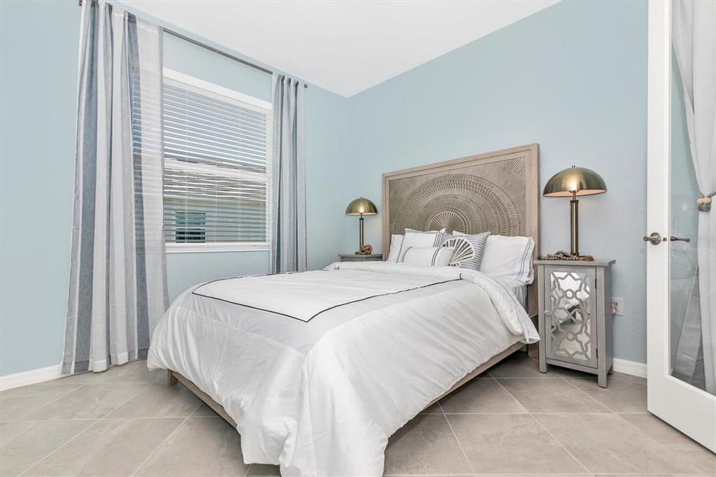 17180 Jadestone Court Venice, FL 34293 - Photo 27 of 98 a bedroom with a bed and a night stand