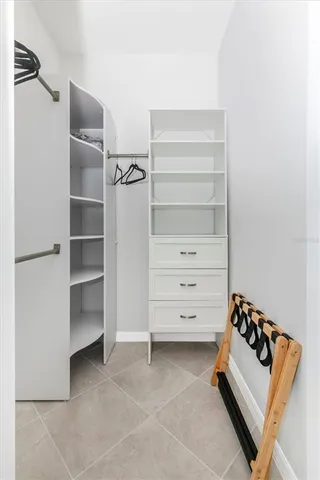 a living room with patio furniture and a large window