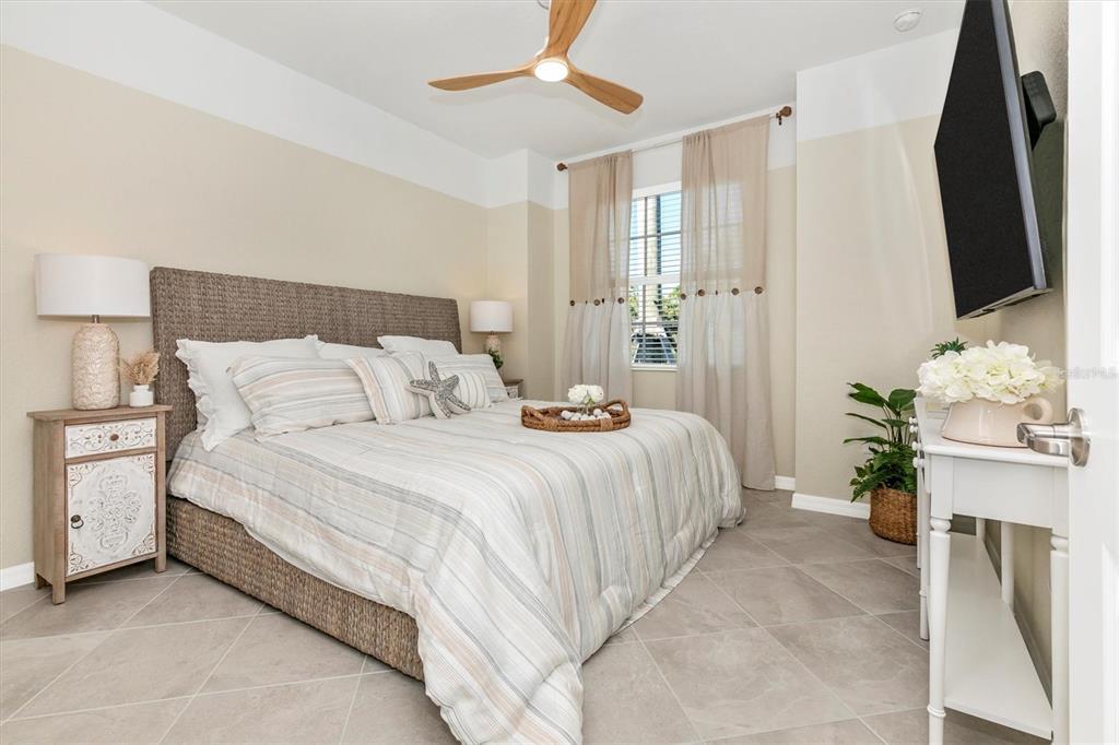 17180 Jadestone Court Venice, FL 34293 - Photo 30 of 98 a bedroom with a bed potted plant with the mirror