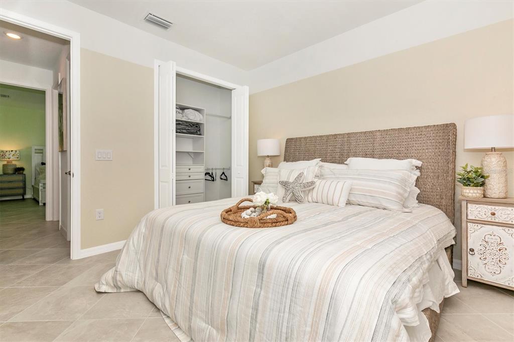 17180 Jadestone Court Venice, FL 34293 - Photo 31 of 98 a bedroom with a bed and a view of bathroom